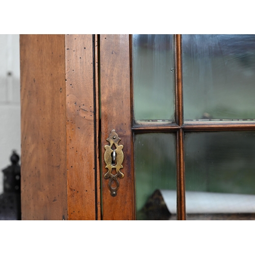 116 - An 18th century fruitwood glazed corner cupboard with painted interior, 102 cm h