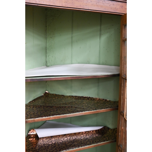 116 - An 18th century fruitwood glazed corner cupboard with painted interior, 102 cm h