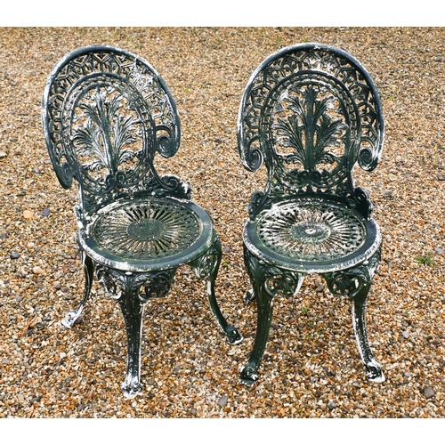 12 - A circular Victorian style cast metal terrace table to/with two matching chairs, old distressed pain... 