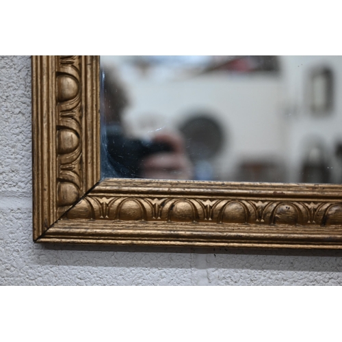 129 - A rectangular wall mirror in giltwood egg and dart frame pattern frame, 104 x 62 cm