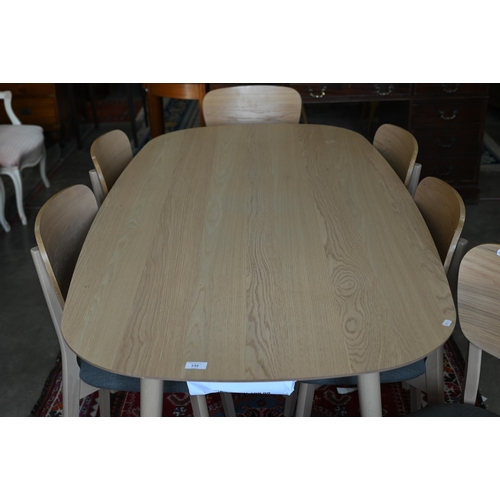 132 - A modern light ash dining table on turned supports 176 x 90 x 76 cm high to/w set of six matching di... 