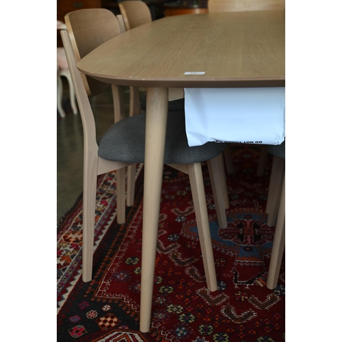 132 - A modern light ash dining table on turned supports 176 x 90 x 76 cm high to/w set of six matching di... 