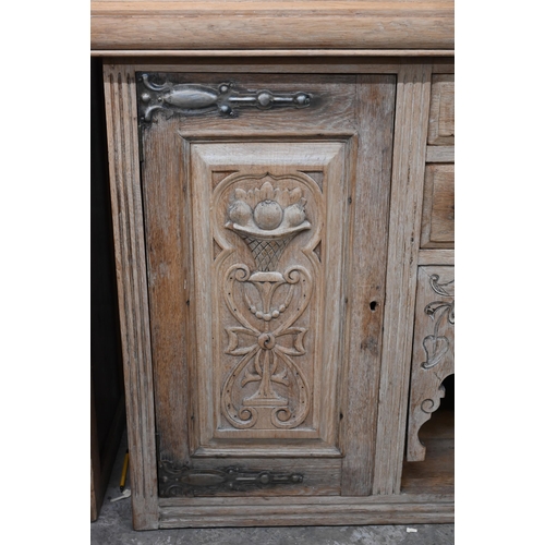 137 - An Art Nouveau light oak sideboard with two central drawers with carved cupboard doors each side 154... 