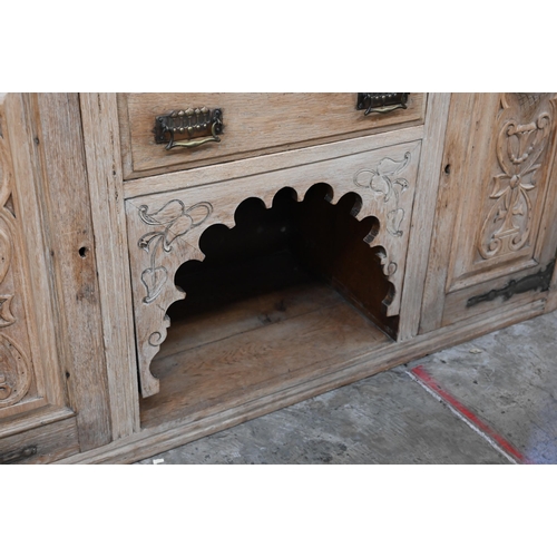 137 - An Art Nouveau light oak sideboard with two central drawers with carved cupboard doors each side 154... 