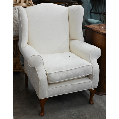 141 - A Georgian style wingback armchair with floral damask fabric and cabriole front legs