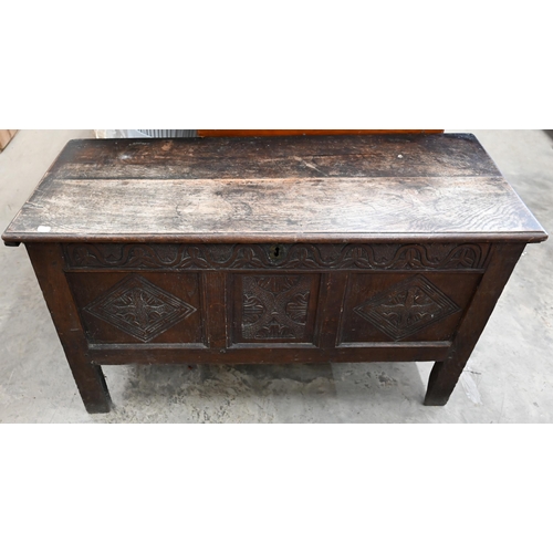 146 - A small antique oak coffer, traditional panelled construction with carved front and hingd top, 106 x... 