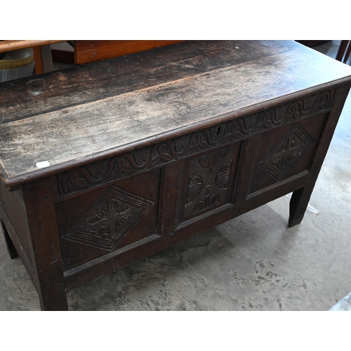 146 - A small antique oak coffer, traditional panelled construction with carved front and hingd top, 106 x... 