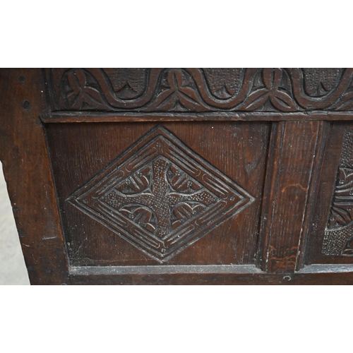 146 - A small antique oak coffer, traditional panelled construction with carved front and hingd top, 106 x... 