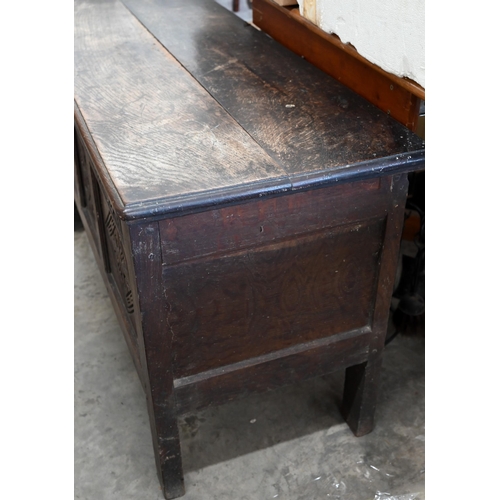 146 - A small antique oak coffer, traditional panelled construction with carved front and hingd top, 106 x... 