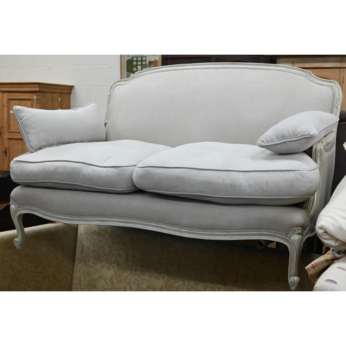 149 - A French two seater sofa with cream painted frame and stone linen upholstery