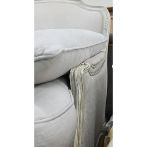 149 - A French two seater sofa with cream painted frame and stone linen upholstery