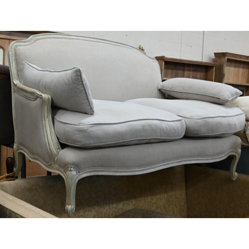 149 - A French two seater sofa with cream painted frame and stone linen upholstery