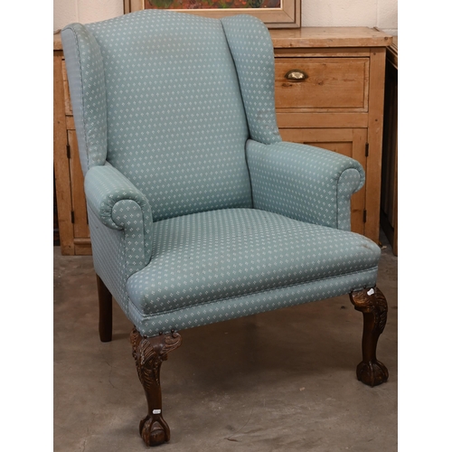 151 - A Georgian style wingback armchair, patterned teal upholstery and carved cabriole front legs with ba... 