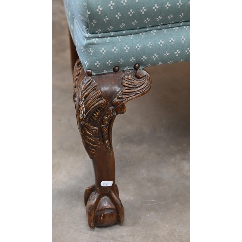 151 - A Georgian style wingback armchair, patterned teal upholstery and carved cabriole front legs with ba... 