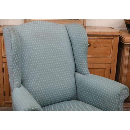 151 - A Georgian style wingback armchair, patterned teal upholstery and carved cabriole front legs with ba... 