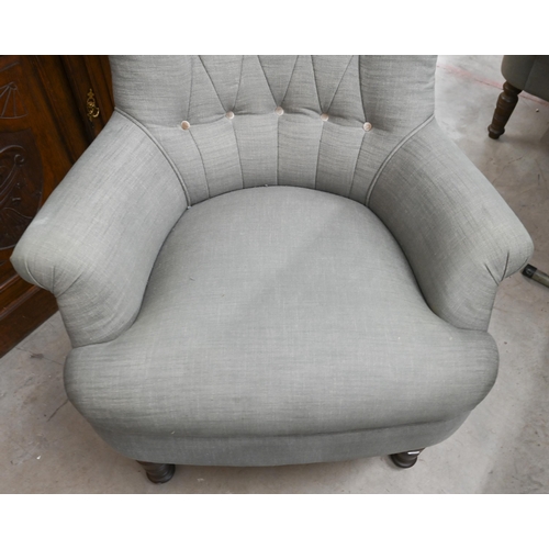 155 - A pair of modern button back armchairs in grey fabric with turned front legs (a/f)