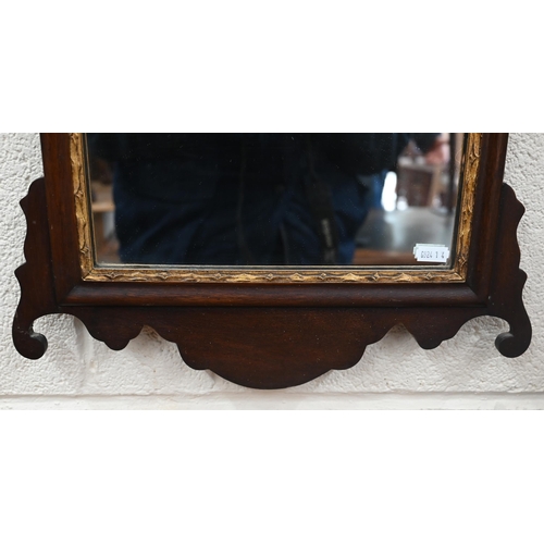 169 - A wall mirror in fret-cut mahogany frame surmounted by gilt ho-ho bird (a/f), 70 x 40 cm