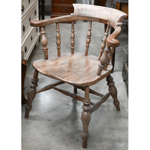 171 - An antique ash and elm spindle back captains chair, shaped seat and turned legs with stretchers