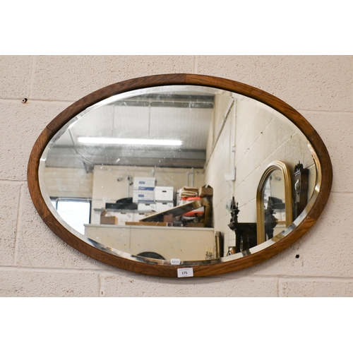 175 - A bevelled oval wall mirror in oak frame, 74 x 54 cm