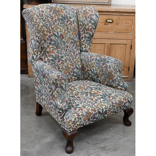 186 - An antique mahogany framed wingback armchair with flora and fauna upholstery, 76 x 85 x 102 cm