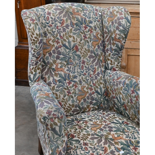 186 - An antique mahogany framed wingback armchair with flora and fauna upholstery, 76 x 85 x 102 cm