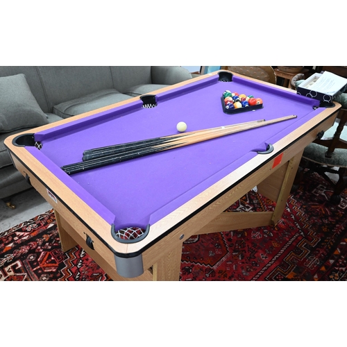 187 - A BCE Rolling lay-flat 5ft pool table with purple baise c/w balls, triangle, four cues, chalk and as... 