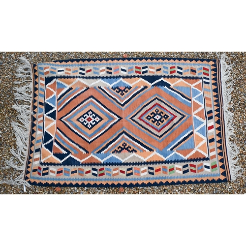 194 - An orange/blue/cream geometric design kelim rug, 202 x 134 cm