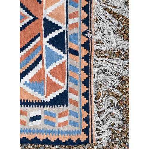 194 - An orange/blue/cream geometric design kelim rug, 202 x 134 cm