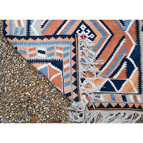 194 - An orange/blue/cream geometric design kelim rug, 202 x 134 cm