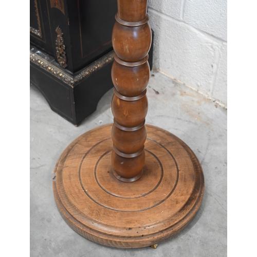 196 - An early 20th century hardwood adjustable duet music stand on bobbin turned column and circular base