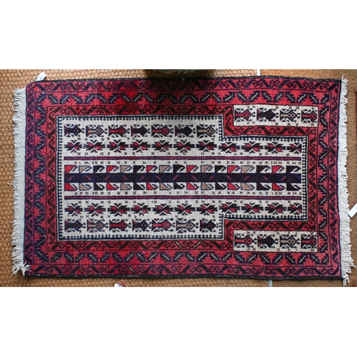 197 - A Persian Balouch prayer rug, cream ground with red borders 129 x 82 cm to/w machine made square rug... 