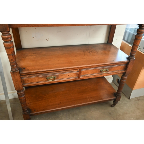 198 - An Edwardian mahogany three-tier buffet with two drawers and turned supports on casters, 104 x 46 x ... 