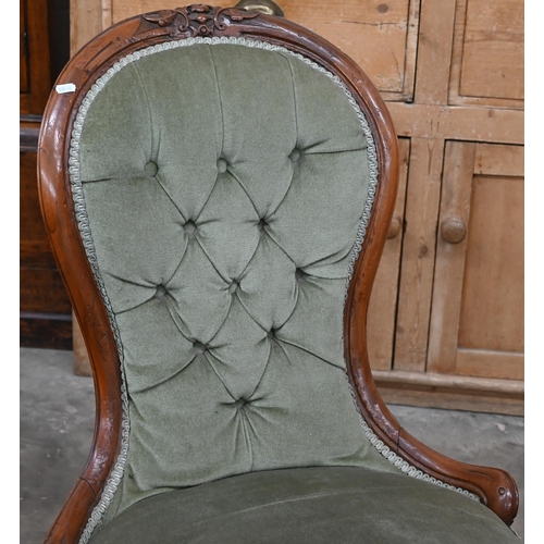 199 - A Victorian carved mahogany nursing chair with green dralon button back upholstery