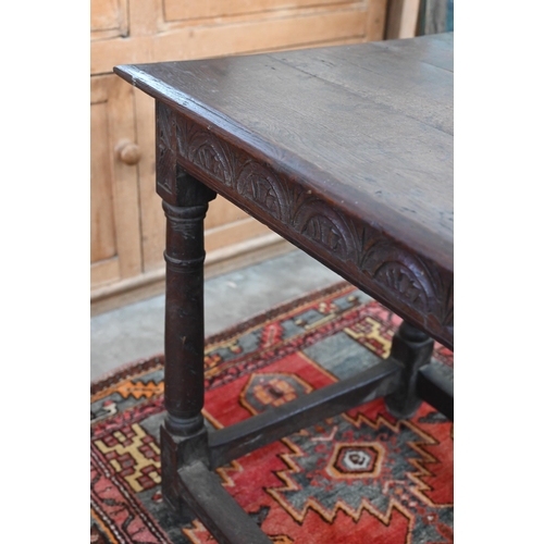 204 - An antique oak hall table with lunette carved frieze and turned supports united by stretchers, 100 x... 