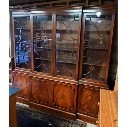 207 - A reproduction mahogany breakfront library bookcase with astragal glazed doors enclosing adjustable ... 