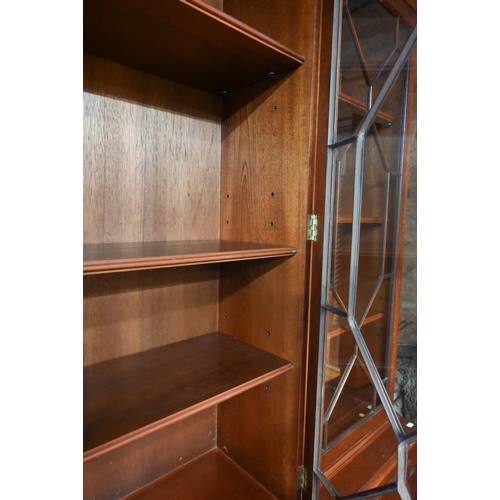 207 - A reproduction mahogany breakfront library bookcase with astragal glazed doors enclosing adjustable ... 