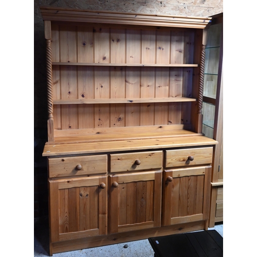 209 - A modern stained pine kitchen dresser with plate rack over three drawers and panelled cupboards, 138... 