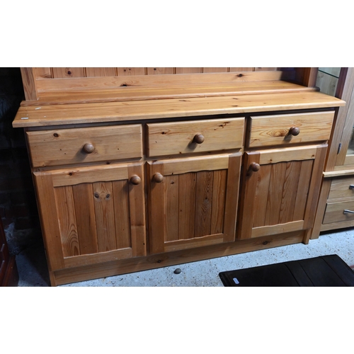 209 - A modern stained pine kitchen dresser with plate rack over three drawers and panelled cupboards, 138... 