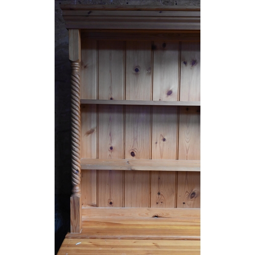 209 - A modern stained pine kitchen dresser with plate rack over three drawers and panelled cupboards, 138... 