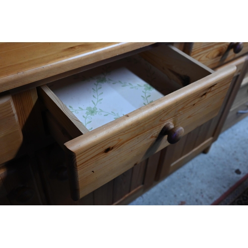 209 - A modern stained pine kitchen dresser with plate rack over three drawers and panelled cupboards, 138... 