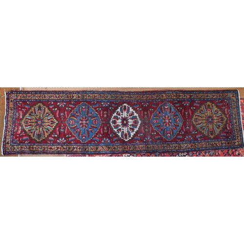 212 - A Persian Hamadan runner with five floral medallions on dark red ground, 333 x 89 cm to/w a Turkoman... 