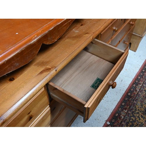 214 - A modern pine (possibly Ducal) sideboard with eight drawers, 166 x 46 x 74 cm