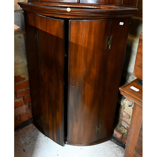 218 - An antique mahogany barrel front corner cabinet, 96 cm high