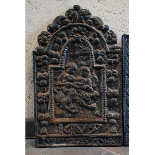 22 - Two old cast iron fire backs, one centred by a figure of a Bishop, the other with an arched top and ... 