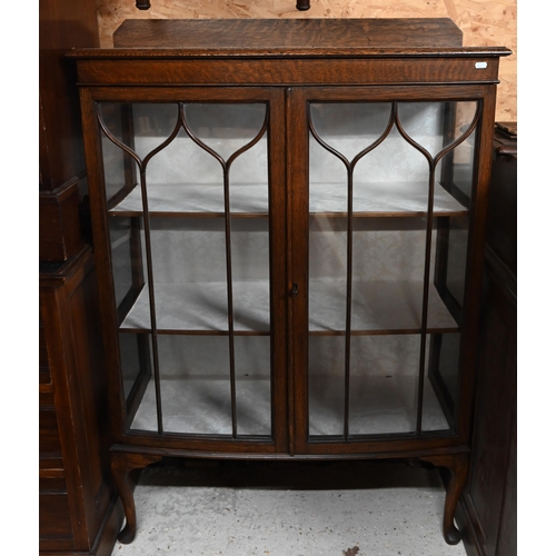 221 - # An oak bowfront display cabinet with glazed doors and cabriole supports, 90 x 36 x 130 cm high