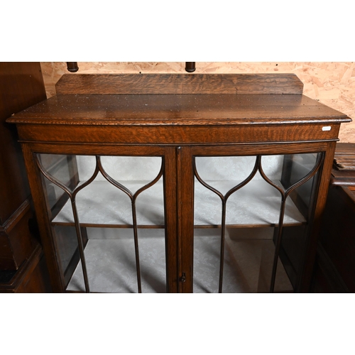 221 - # An oak bowfront display cabinet with glazed doors and cabriole supports, 90 x 36 x 130 cm high