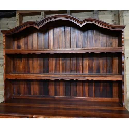 25 - A South African stinkwood dresser, the open rack over a base centred by four drawers, on short cabri... 