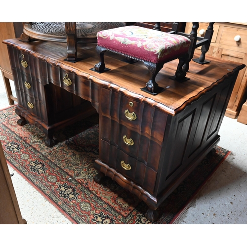 27 - An African pedestal desk with seven drawers opposing two cupboards on short cabriole feet, 152 cm w ... 