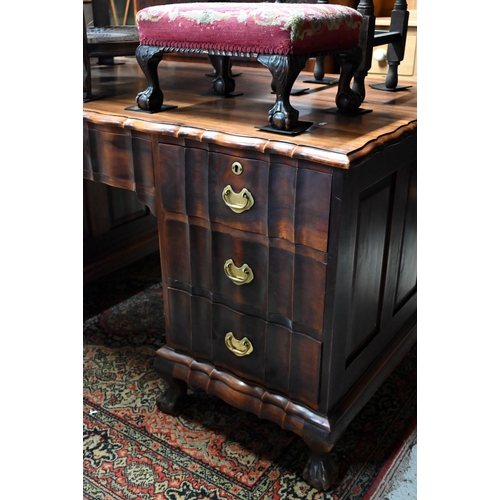 27 - An African pedestal desk with seven drawers opposing two cupboards on short cabriole feet, 152 cm w ... 