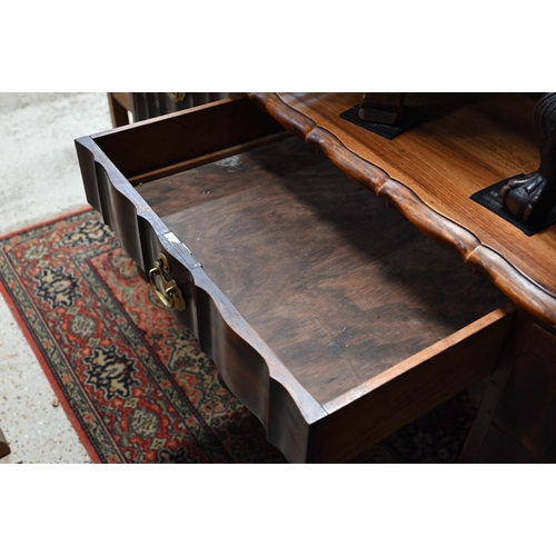 27 - An African pedestal desk with seven drawers opposing two cupboards on short cabriole feet, 152 cm w ... 